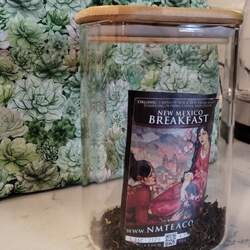 A clear container of New Mexico Breakfast black tea, running low, with a succulent pattern in the background.