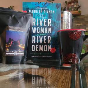 A bag of Luminaria Black Tea pictured next to a book by Jennifer Givhan titled 